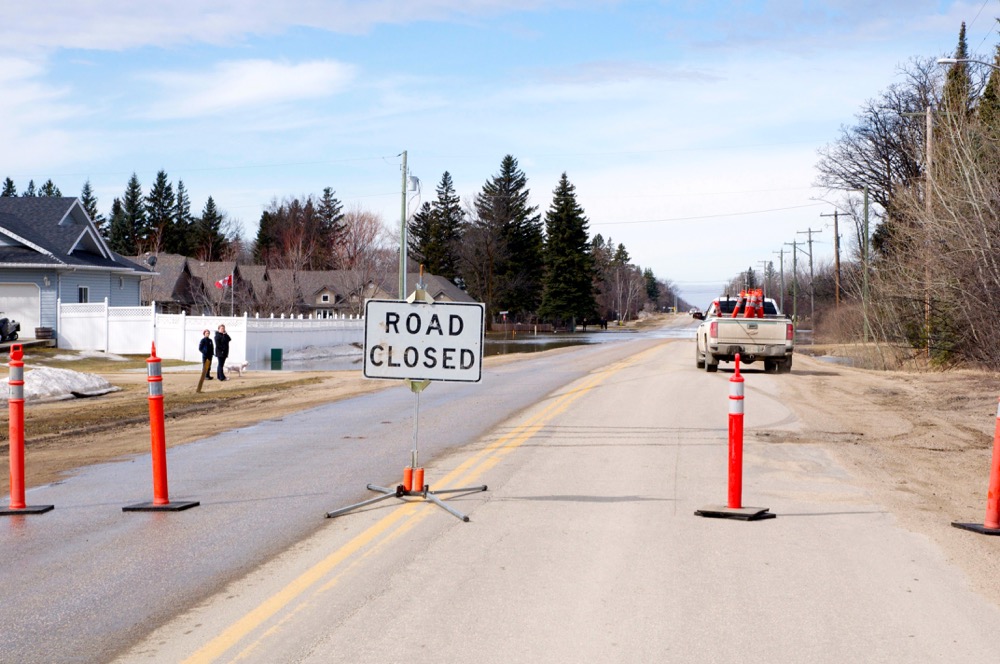 Provincial Hwy 247 at Carman was closed April 2 as floodwaters came over the road threatening houses.