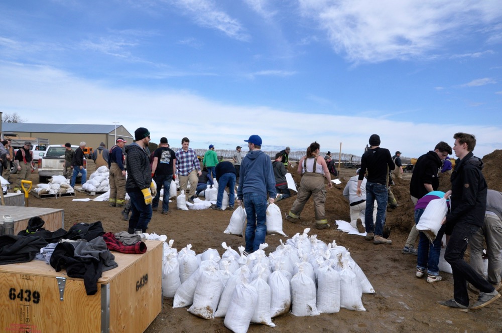 Volunteers fill sandbags near Carman after ice jams on the Boyne River caused flooding that threatened dozens of homes.