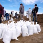 More than 100 volunteers came out to fill sandbags near Carman as flood waters rose April 2. Although the town is protected by a diversion, ice jams caused the Boyne River to spill its banks.