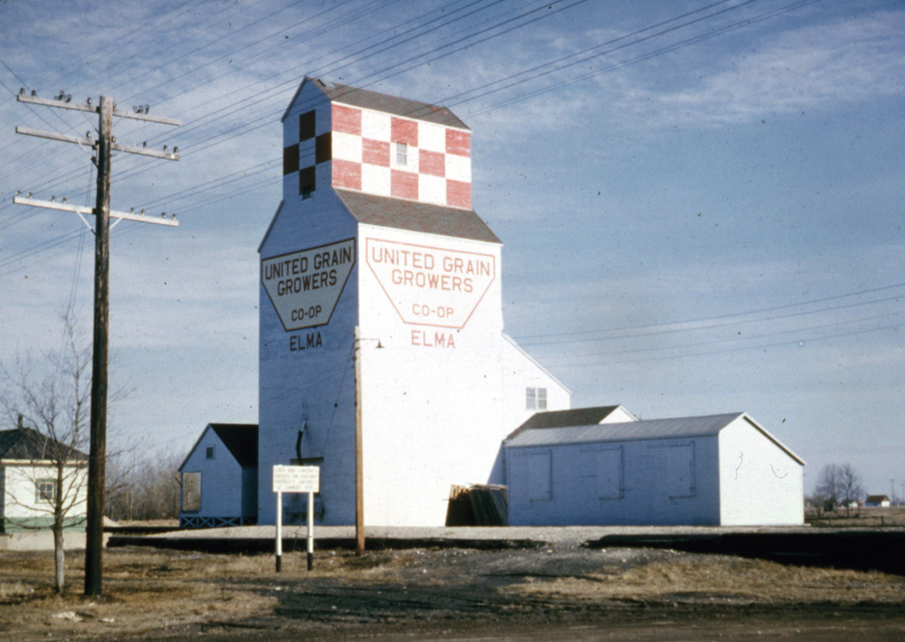 A 40,000-bushel wooden grain elevator at Elma was built in 1950 by the Canadian Consolidated Grain Company. Sold to United Grain Growers in April 1959, along with the rest of the company’s elevators, low grain-handling volume and increasing costs caused it to be closed in March 1964. The building was moved to Whitemouth and converted into an annex for an existing elevator there until the facility was closed in July 1979 and removed.