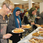 Maren Mueller, (left) with Manitoba Women’s Institute (Woodmore) joins with Meharunisa Kinnarath (centre) and Hiba Kasem, two of more than a dozen women with the Canadian Muslim Women’s Institute who joined the Woodmore group for a halal potluck held April 22 in the village hall at Roseau River.