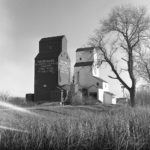 In July 1972, a Manitoba Pool elevator at Rounthwaite, on the CNR Wawanesa Subdivision in what is now the Municipality of Oakland-Wawanesa, was destroyed by fire. It had been purchased from Federal Grain shortly before the fire and was to have been repainted in the new corporate colours a few days later. A new elevator was constructed between 1974 and 1975 and designated as Pool B, joining a Pool elevator dating back to 1928, seen in this photo from October 1978. When the railway line was abandoned in December 1983, the old elevator was demolished and the new one was moved to Nesbitt. It operated there until it was sold into private ownership. The railway line at Nesbitt was removed in mid-2016.