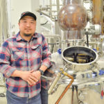 Jason Kang, master distiller at Capital K Distillery, stands in front of the network of stills at his location in Winnipeg.