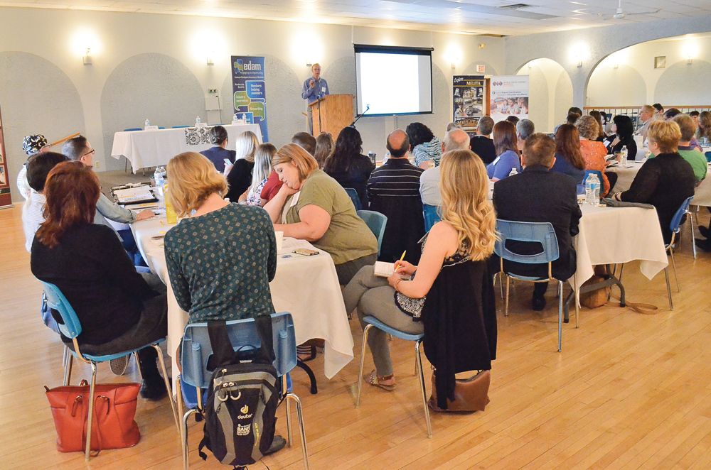 About 40 economic development officers from rural communities listen to economist John Harper speak on what’s to come in 2017.