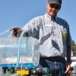 Tom Wolf, co-founder of Agrimetrix and Sprayers 101, models the importance of sprayer cleaning to avoid accidental application of canola-unfriendly chemicals.