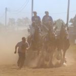 Britney and Charity Martin of Strathclair head to the 4 Hitch Class at the Manitoba Clydesdale Classic with the help of Eric Thevenot of Strathclair. The show ring was watered down but it was still a dusty trail.
