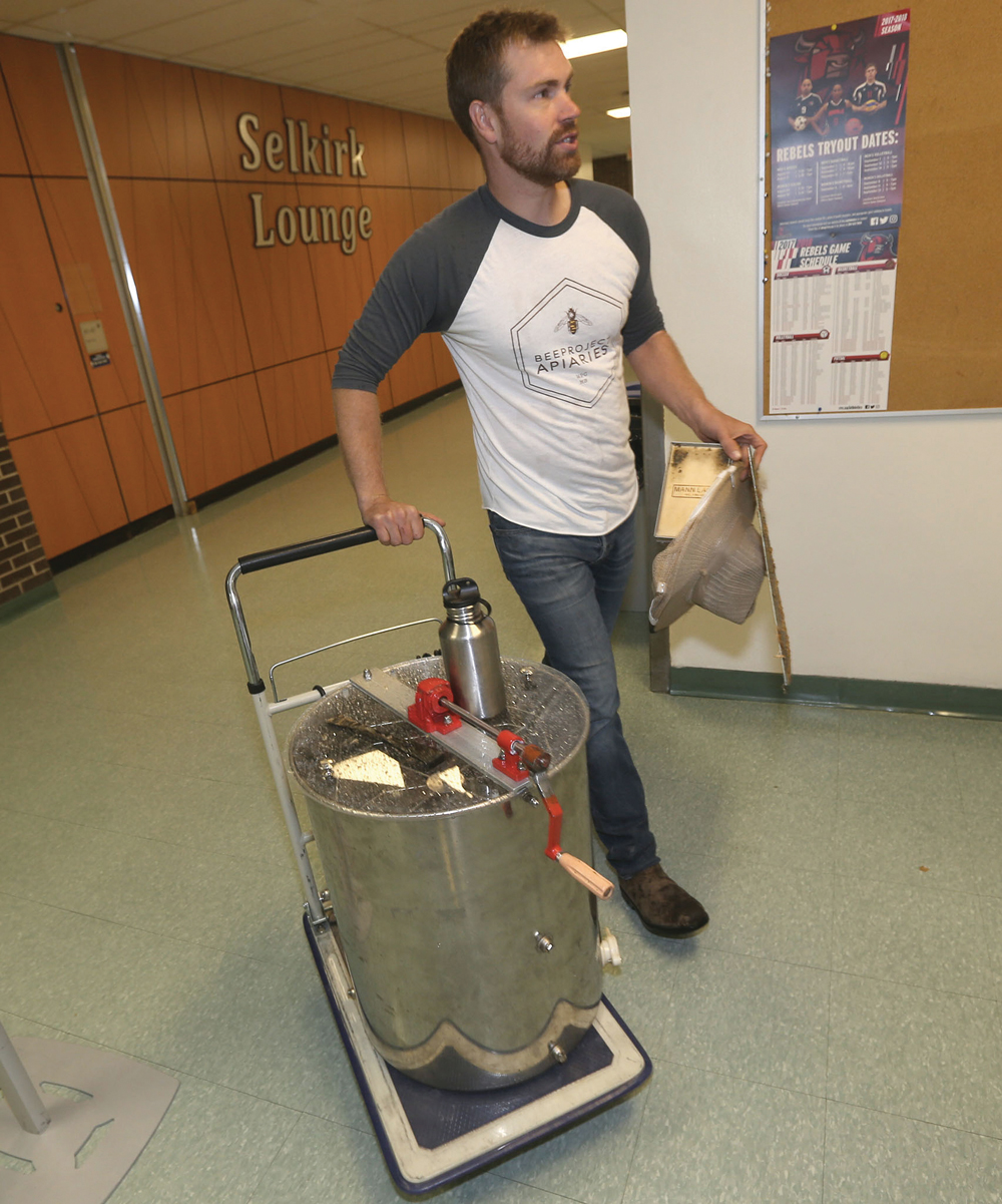 Chris Kirouac of Beeproject Apiaries demonstrates honey extraction at  Red River College.