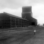 A 30,000-bushel wooden grain elevator at Curtis, in the Rural Municipality of Portage la Prairie, was built in 1938 by Portage businessman Andy Forsythe. His Forsythe Elevator Company was one of the first companies west of Winnipeg to use grain-drying equipment. He introduced a fairer method for determining dockage, and successfully challenged the Canadian Pacific Railway over its blockage of highway rights-of-way, resulting in revised railway practices that are still in place today. Sold to Reliance Grain in 1946, the Curtis elevator was resold to Manitoba Pool in 1948 and a large balloon annex was built beside it in 1951. The elevator closed in July 1972 and was removed from the site.