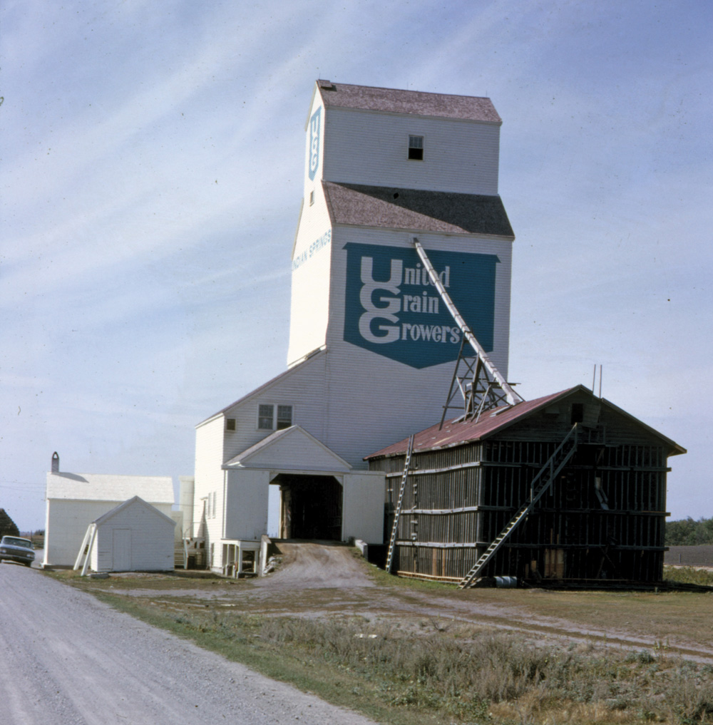 A 55,000-bushel grain elevator and balloon annex at the railway siding of Indian Springs, on the CNR Carman Subdivision in the Swan Lake First Nation, was built by United Grain Growers in 1951. It replaced an earlier elevator constructed by the provincial government around 1916. During its 24 years in operation, there were just two agents: Tim Conrad (1907-94) and his son Roland. The elevator closed on December 5, 1975 and was removed from the site.