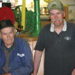 Willard (l), and son David Moffett have common interest in keeping farming history including “old iron” working.