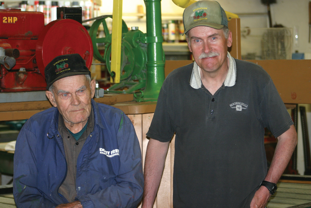 Willard (l), and son David Moffett have common interest in keeping farming history including “old iron” working.