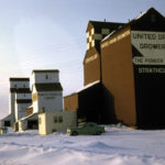 When this photo was taken in 1962, there were three elevators in the village of Strathclair. The United Grain Growers elevator in the foreground dates from around 1930 and its crib annex from 1957. The Manitoba Pool elevator in the background was opened by the Province Elevator Company in 1933. Sold to the Pool in 1948, a new elevator was built in 1957 and the older elevator was converted to an annex, later replaced with two large crib annexes. All elevators, including one in the middle owned by Pioneer Grain, were sold to Pool in 1974 and have since been removed from the site.