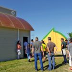 Delegates participating in the Canadian Society for Bioengineering convention Food, Fuel and Fibre for a Sustainable Future enter the ‘Green Garage’ site at the University of Manitoba’s Alternative Village during an August tour.