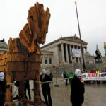 Demonstrators pull a wooden model of the Trojan Horse during a protest against the Comprehensive Economic Trade Agreement (CETA) in front of the Parliament in Vienna, Austria on the eve of the deal coming into provisional effect.