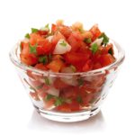 Bowl of fresh salsa dip isolated on white background