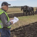 Plowing judge John Semple of Alexander examines a competitor’s crown.