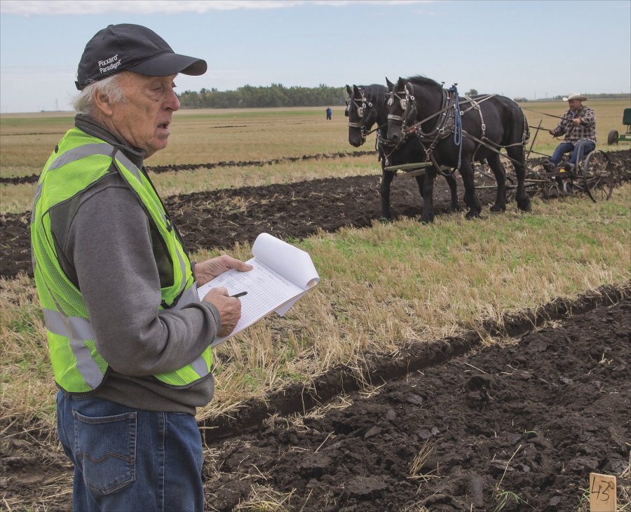 Plowing judge John Semple of Alexander examines a competitor’s crown.