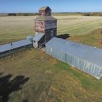 A 32,000-bushel wooden elevator on a farm in the RM of Portage la Prairie was built at Oakville in 1918 by Ogilvie Flour Mills. An annex was built beside it in 1951, increasing the total capacity to 62,000 bushels. Sold around 1960 to Manitoba Pool, it became known as “Pool B.” Closed in 1975, the elevator was sold and moved to its present site where it was used to store grain for an adjacent hog barn. Its rope-driven leg broke down in the early 1990s. Plans call for it to be deconstructed this fall so the lumber can be reused.