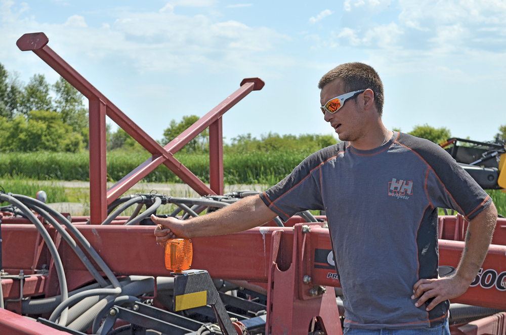 Don Rourke fields equipment questions during a field tour near Minto.