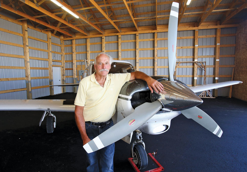 Don Dewar with his Comanche aircraft in Dauphin.