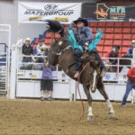 Holding on for all he’s worth, Calder Peterson of Glenworth, Sask. completes his eight seconds in the saddle bronc class.