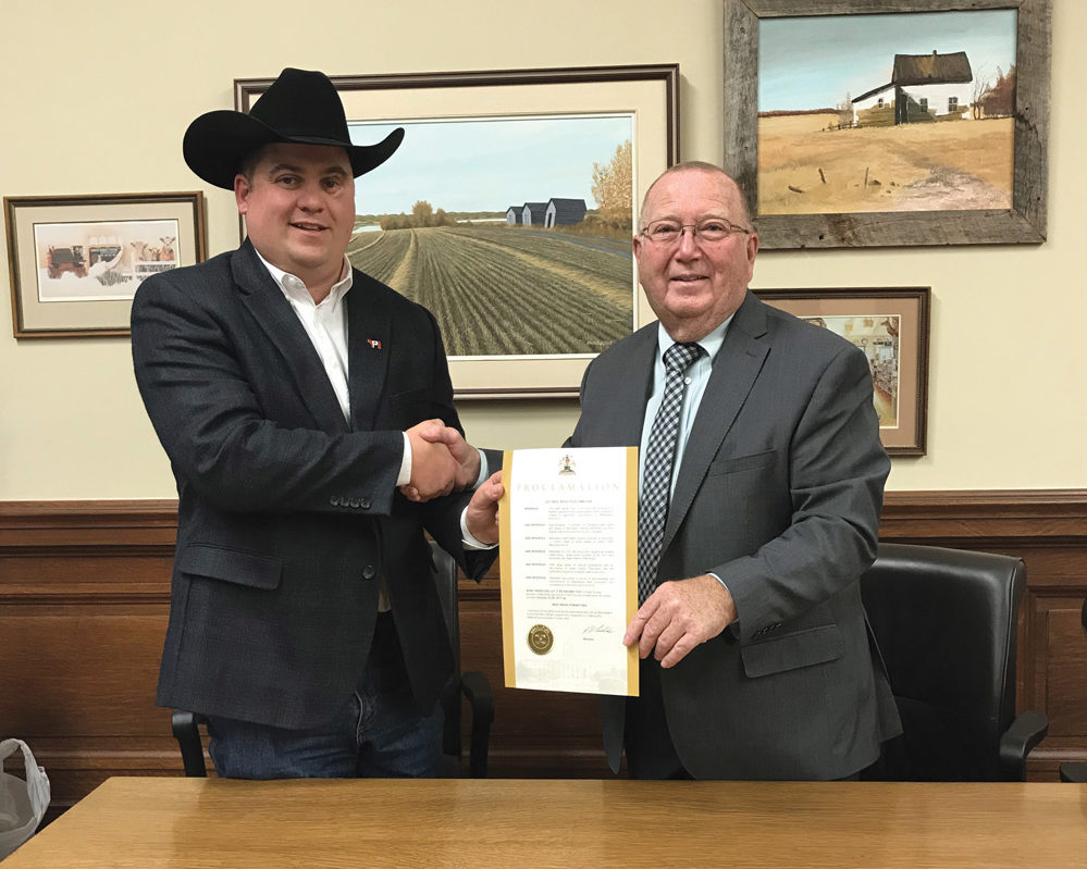 Manitoba Beef Producers president Ben Fox (l to r) and Manitoba Agriculture Minister Ralph Eichler mark the proclamation of Beef Week 2017.