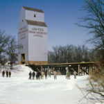 In 1951, United Grain Growers constructed a 35,000-bushel wooden grain elevator at the Cawdor siding on the CNR Oakland Subdivision, near the Whitemud River in what is now the Municipality of WestLake-Gladstone. Grain volumes shipped from the elevator did not meet the company’s expectations so, in 1964, it was moved to Westbourne, the first time that a UGG elevator was moved intact rather than being demolished and rebuilt.