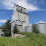 The first grain elevator in McConnell was built by J. H. McConnell and sold to the Canadian Elevator Company. Between 1926 and 1927, it was taken over by McConnell Cooperative Elevator Association. In 1928, the old elevator was demolished and a new one was constructed on the same site. A balloon annex was built beside it in 1940. Major renovations in 1968 included construction of a new driveway and office, and installation of a 40-ton scale. The final grain delivery occurred on December 16, 1978, the same day as the final train passed through town. The tracks were removed in May 1979 and the elevator was sold to a local farmer.