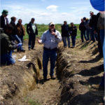 Dr. Alan Moulin takes tour attendees through the field.
