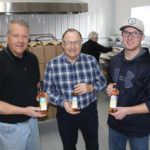 Winnipeg Beach-area farmer David Reykdal, Bruce Dalgarno from Newdale and Keenan Wiebe of Starbuck display bottles of the Northern Lights, Big Prairie Sky and Heartland canola oils produced from seed from their respective farms.
