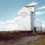 A 28,000-bushel grain elevator at Rossendale, 18 miles southwest of Portage la Prairie, was built in 1916 by the Grain Growers’ Grain Company, predecessor of United Grain Growers. Over the years, two annexes were built to increase its capacity, a 25,000-bushel balloon annex in 1951 (demolished around 1970) and a 30,000-bushel crib annex in 1954. Closed in 1975, the elevator was demolished three years later while the crib annex was moved to the Baker Hutterite Colony. Along the way, the annex had to be hauled up a 70-foot hill under muddy conditions. This photo was one of several taken by Eddie Maendel, now living at the Airport Hutterite Colony, who helped with the move. The annex is still in use.