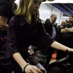 Ardyn Williams of Souris tries her hand at the wheel of a virtual combine Jan. 16, one of over 800 booths at Ag Days 2018.