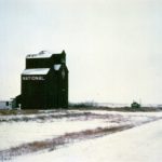 There were once two wooden grain elevators at Menzie, a community along Highway No. 45 east of Oakburn. A 35,000-bushel elevator was built in 1913 by the British America Elevator Company, which in 1940 merged with three other companies to become National Grain. A 27,000-bushel elevator was built in 1918 by a group of 38 local farmers, each of whom contributed $100, operating as the Ruthenian Farmers Elevator Company. In 1931, it was taken over by Federal Grain then sold to National in 1950. The two elevators were operated separately until 1955 when they were licensed as a single 49,000-bushel facility. Closed in 1973, the elevators were demolished in 1981.