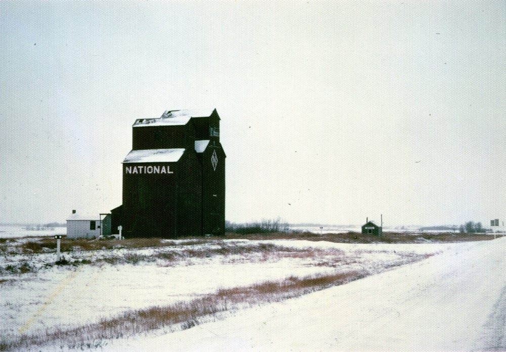 There were once two wooden grain elevators at Menzie, a community along Highway No. 45 east of Oakburn. A 35,000-bushel elevator was built in 1913 by the British America Elevator Company, which in 1940 merged with three other companies to become National Grain. A 27,000-bushel elevator was built in 1918 by a group of 38 local farmers, each of whom contributed $100, operating as the Ruthenian Farmers Elevator Company. In 1931, it was taken over by Federal Grain then sold to National in 1950. The two elevators were operated separately until 1955 when they were licensed as a single 49,000-bushel facility. Closed in 1973, the elevators were demolished in 1981.