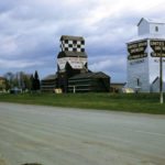 Altamont, in the RM of Lorne, was served by three elevators when this photo was taken in 1962. The right one was the oldest, built in 1905 by Ogilvie Flour Mills and sold to United Grain Growers in 1960. It was sold and torn down in 1967. The UGG elevator beside it dated from 1925, replacing an earlier elevator built in the early 20th century by the Dominion Elevator Company. Closed in 1993, it was demolished the following year. The left-most elevator, near the railway station, was constructed in 1932 by Federal Grain. Sold to Manitoba Pool in 1989, it was demolished sometime between 1995 and 1997. A monument in town commemorates the elevators and the men who operated them through the years.