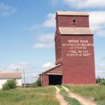 A 30,000-bushel elevator in Moore Park, in what is now the RM of Minto-Odanah on the former CPR Varcoe Subdivision, was built in 1929 by Manitoba Pool for a local association. It closed in July 1978 when the rail line was abandoned. By the time this photo was taken in July 1989 by Brandon University geographer John Everitt, the elevator had been vacant for years. Gone was a balloon annex from 1951 that had doubled its capacity. Also gone was a second, smaller elevator that stood behind this one. Built in 1905 by the Lake of the Woods Milling Company, it was acquired by Pool in 1960 as its “B” elevator. It closed in July 1978 too and was demolished in 1981. The Pool “A” elevator stood until at least the mid-1990s but has been removed from the site.