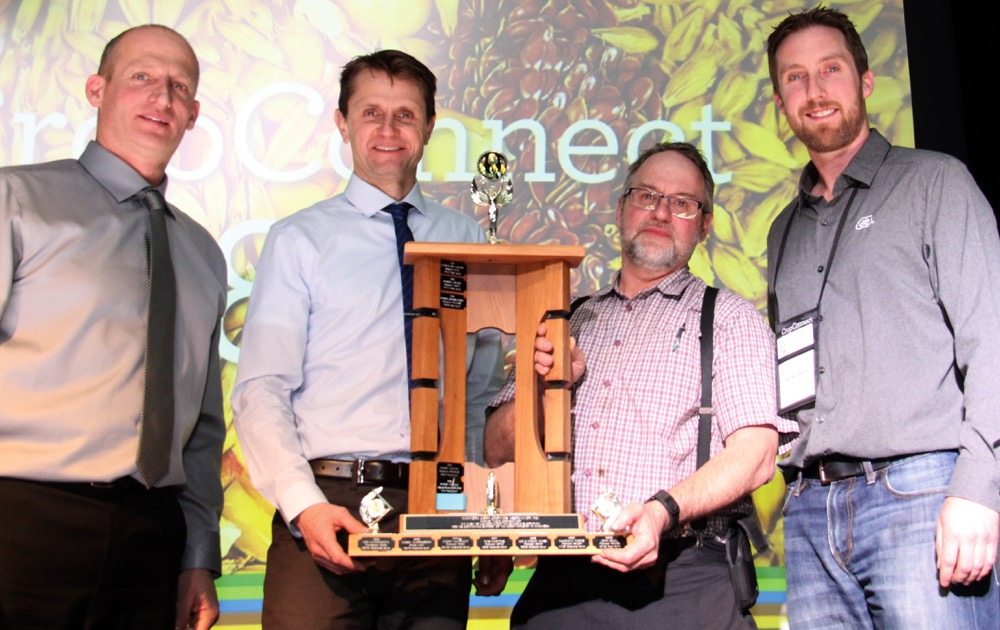 Baker Colony won the Manitoba Corn Growers Association’s (MCGA) corn yield competition for the third year in a row with a record yield of 306.4 bushels an acre. The results were announced Feb. 14 at the CropConnect banquet in Winnipeg. Mack Waldner (second from right) received the competition trophy from MCGA president Myron Krahn (second from left) along with MCGA director Leonard Wiebe (l) and $1,000 from John McCulloch of DuPont Pioneer.