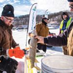 Judge Dennis Schram of Ninette prepares to measure what turned out to be a 61-centimetre jackfish for Ron Kon of Carman.