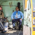 Shaun Majumder of CBC sketch comedy show “This Hour Has 22 Minutes” chats it up with Victor Boulet of Dunrea and Ken Shackel of Killarney in Boulet’s converted 1960s-era school bus. Majumder was in character for a sketch on Canadian winter pastimes.