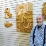 Elias Wipf with some intarsia pieces created by him and his students.