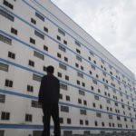 A worker outside a seven-storey pig building of Guangxi Yangxiang’s farm at Yaji Mountain Forest Park in Guangxi province, China, March 21, 2018.