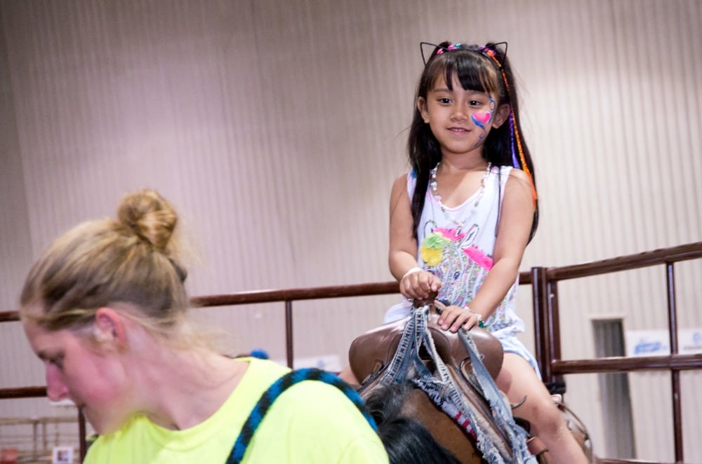 Adriana Garcia takes a turn in the saddle at the 2018 Manitoba Summer Fair in Brandon.