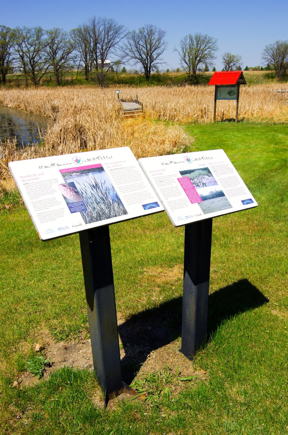Signs in front of the Wetlands Discovery Trail near Cypress River deliver a conservation-focused message. 