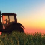 Sitting long hours in the tractor can cause lower back pain.