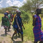 South Sudanese women walk to the site of a UN’s World Food Program (WFP) food aid air drop near the town of Katdalok, in Jonglei State of South Sudan July 30, 2018.