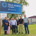 Calvin Vaags (far right) poses with some of his senior and front office staff in front of True North Foods north of Carman. The only federally certified slaughter plant in Manitoba,the facility is expected to add the USDA’s check of approval in the near future.