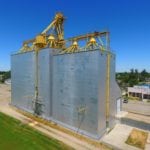 In 1981, Manitoba Pool built a 60,000-bushel crib annex on the west side of its 54-year-old elevator at Cartwright. Then, between October 1986 and December 1987, it constructed a 145,000-bushel composite-style (elevator and annex in a single crib) structure on the west side of the earlier annex (on the right in this 2018 photo) and demolished the old elevator on the east end. The facility was opened officially in April 1988. Closed by Agricore in July 2001 and put up for sale, the elevator was purchased by the Willow Creek Hutterite Colony which also rents out storage space to other farmers. The adjacent railway line was abandoned in May 2008.  