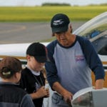 Pilot Russ Hamilton goes over a pre-flight introduction of components of an aircraft to two of the 24 youth registered for the COPA for Kids program at the Shoal Lake Airport.