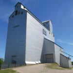 On March 5, 1974, the Manitoba Pool elevator and two annexes at Russell were destroyed by fire, along with 90,000 bushels of wheat. Construction of a replacement began within three months and, on January 30, 1975, a 170,000-bushel composite-style elevator (with elevator and annex combined into a single unit) was opened officially. Closed by Agricore in 2001 and sold to local interests, the off-track facility, seen here in June 2018, remains in use for private grain storage.