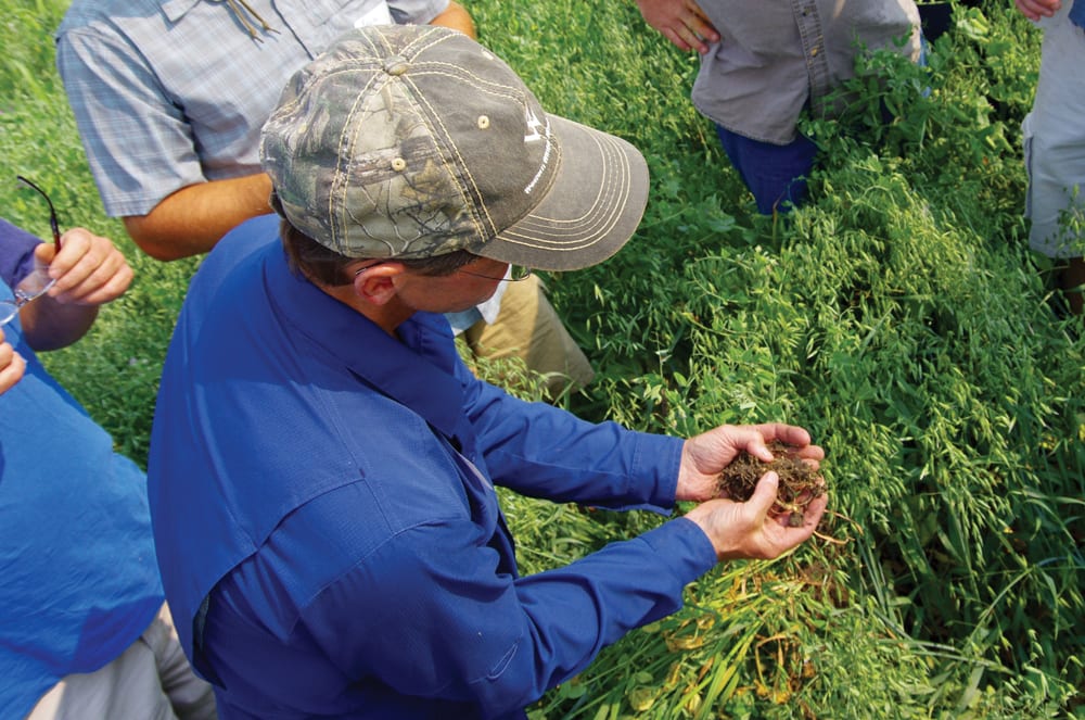 Field tour attendees dig into the soil structure at Borderland Agriculture during a summer field tour. Brooks and Jen White will represent Manitoba at Canada’s Outstanding Young Farmers National Event next month.